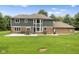 Rear exterior view of a two-story home with a concrete patio and well-maintained lawn at 2871 Mullinix Rd, Greenwood, IN 46143