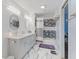Modern bathroom with dual vanity, marble floors, and textured wall at 2871 Mullinix Rd, Greenwood, IN 46143