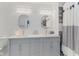 Elegant bathroom with dual sinks, textured walls, and modern lighting at 2871 Mullinix Rd, Greenwood, IN 46143