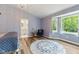 Charming bedroom with wood-look flooring and a cozy sitting area at 2871 Mullinix Rd, Greenwood, IN 46143