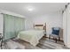 Comfortable bedroom featuring stylish wood-look flooring, chair and a queen-size bed at 2871 Mullinix Rd, Greenwood, IN 46143