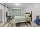 Comfortable bedroom with modern flooring, television, accent chair, and barn-style doors at 2871 Mullinix Rd, Greenwood, IN 46143