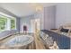 Bright bedroom with neutral decor, wood-look floors and a view of the ensuite at 2871 Mullinix Rd, Greenwood, IN 46143