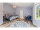 Vaulted bedroom with wood-look flooring and a view of the bathroom at 2871 Mullinix Rd, Greenwood, IN 46143