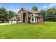 A picturesque two-story home with a lush green lawn and well-manicured landscaping at 2871 Mullinix Rd, Greenwood, IN 46143