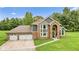 Stunning brick and gray two-story home featuring a three-car garage and arched entry at 2871 Mullinix Rd, Greenwood, IN 46143