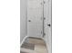 Hallway featuring wood floors and white paneled doors with black hardware at 2871 Mullinix Rd, Greenwood, IN 46143