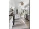 Bright kitchen with stainless appliances, white cabinets, granite countertops, and wood-look flooring at 2871 Mullinix Rd, Greenwood, IN 46143