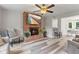 Cozy living room features a brick fireplace with mounted TV and light wood-look floors at 2871 Mullinix Rd, Greenwood, IN 46143