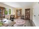 An office space with hardwood floors, a desk, and natural lighting at 2871 Mullinix Rd, Greenwood, IN 46143