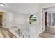 Bright stairwell featuring white railings, a chandelier, and natural light from large window at 2871 Mullinix Rd, Greenwood, IN 46143