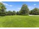 Large yard with grass and scattered trees at 2871 Mullinix Rd, Greenwood, IN 46143