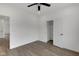 Cozy bedroom with wood-look floors, ceiling fan, closet, and crisp white walls at 2903 Winthrop Ave, Indianapolis, IN 46205