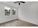 Bedroom featuring wood-look floors, ceiling fan, and large double windows at 2903 Winthrop Ave, Indianapolis, IN 46205