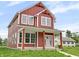 Inviting two-story home featuring a charming front porch and well-manicured lawn on a sunny day at 2903 Winthrop Ave, Indianapolis, IN 46205