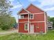 Two-story home with red siding, white trim, and a balcony overlooking the street at 2903 Winthrop Ave, Indianapolis, IN 46205