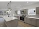 Modern kitchen featuring a central island, stainless steel appliances, and eye-catching backsplash at 2903 Winthrop Ave, Indianapolis, IN 46205