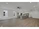 Bright, open-concept living room and kitchen with stainless steel appliances and hardwood floors at 2903 Winthrop Ave, Indianapolis, IN 46205