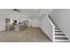 Bright, open-concept living room and kitchen with hardwood floors and staircase at 2903 Winthrop Ave, Indianapolis, IN 46205