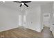 Spacious main bedroom with a ceiling fan, wood-look floors, closet, and ensuite bathroom at 2903 Winthrop Ave, Indianapolis, IN 46205