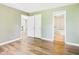 View of a bedroom featuring neutral paint, wood-look flooring and access to the bathroom and living area at 3004 N Timber Ln, Muncie, IN 47304