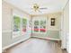 View of the dining room with large bright windows, wood-look flooring and neutral paint at 3004 N Timber Ln, Muncie, IN 47304