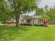 Charming ranch-style home with a well-manicured lawn and mature trees at 3004 N Timber Ln, Muncie, IN 47304