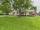 Charming ranch-style home with lush green lawn, mature trees, and well-maintained landscaping at 3004 N Timber Ln, Muncie, IN 47304