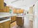 View of the kitchen featuring light wood cabinets, laminate countertops, stainless dishwasher, and a kitchen island at 3004 N Timber Ln, Muncie, IN 47304