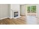 View of the living room featuring a fireplace and a sliding glass door to the exterior deck at 3004 N Timber Ln, Muncie, IN 47304
