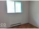 Bright bedroom with hardwood floors and natural light from a large window at 317 Grovewood Dr, Beech Grove, IN 46107