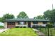 Charming one-story home features a well-maintained lawn and an attached one-car garage at 317 Grovewood Dr, Beech Grove, IN 46107