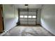 Spacious garage with a functional automatic door and ample room for parking and storage at 317 Grovewood Dr, Beech Grove, IN 46107