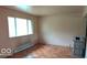 Bright living room with hardwood floors, a large window, and a unique stone heater at 317 Grovewood Dr, Beech Grove, IN 46107