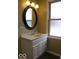 This bathroom boasts a classic design with an oval mirror and a vintage light fixture at 3456 S Sadlier S Dr, Indianapolis, IN 46239
