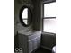 This bathroom boasts a classic design with an oval mirror and a vintage light fixture at 3456 S Sadlier S Dr, Indianapolis, IN 46239