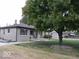 Landscaped front yard with mature tree providing shade and curb appeal to the home at 3456 S Sadlier S Dr, Indianapolis, IN 46239