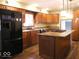 Well-appointed kitchen with island, stainless appliances, granite counters and stylish pendant lights at 3456 S Sadlier S Dr, Indianapolis, IN 46239