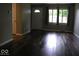 Sunlit living room showcases gleaming hardwood floors and fresh, neutral paint at 3456 S Sadlier S Dr, Indianapolis, IN 46239