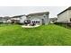 The backyard features a patio with a fire pit, outdoor seating, a lush green lawn and outdoor dining at 3872 New Battle Ln, Bargersville, IN 46106
