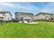 This beautiful backyard features a fire pit, outdoor seating, a lush green lawn, and an outdoor dining area at 3872 New Battle Ln, Bargersville, IN 46106
