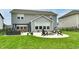 This backyard features a fire pit, outdoor seating, an outdoor dining area, and a lush green lawn at 3872 New Battle Ln, Bargersville, IN 46106