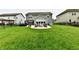 Beautiful backyard features a patio with fire pit, outdoor seating, and a lush green lawn at 3872 New Battle Ln, Bargersville, IN 46106