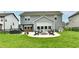 The backyard features a fire pit, outdoor seating, a lush green lawn and an outdoor dining area at 3872 New Battle Ln, Bargersville, IN 46106