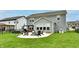This backyard features a fire pit, outdoor seating, an outdoor dining area, and a lush green lawn at 3872 New Battle Ln, Bargersville, IN 46106
