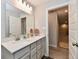 Bright bathroom featuring a double sink vanity and doorway to the hallway at 3872 New Battle Ln, Bargersville, IN 46106