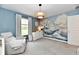 Bright Bedroom with a white dresser, recliner, crib, and unique mural for a playful touch at 3872 New Battle Ln, Bargersville, IN 46106