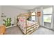 Whimsical bedroom with canopy bed, rainbow bedding, cactus wall art, and bright natural light at 3872 New Battle Ln, Bargersville, IN 46106