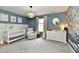 Bright Bedroom with a white crib, comfortable recliner, dresser changing table, and a charming whale mural at 3872 New Battle Ln, Bargersville, IN 46106
