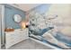 Bedroom dresser with a changing station, round mirror, and whimsical whale airship mural on the wall at 3872 New Battle Ln, Bargersville, IN 46106